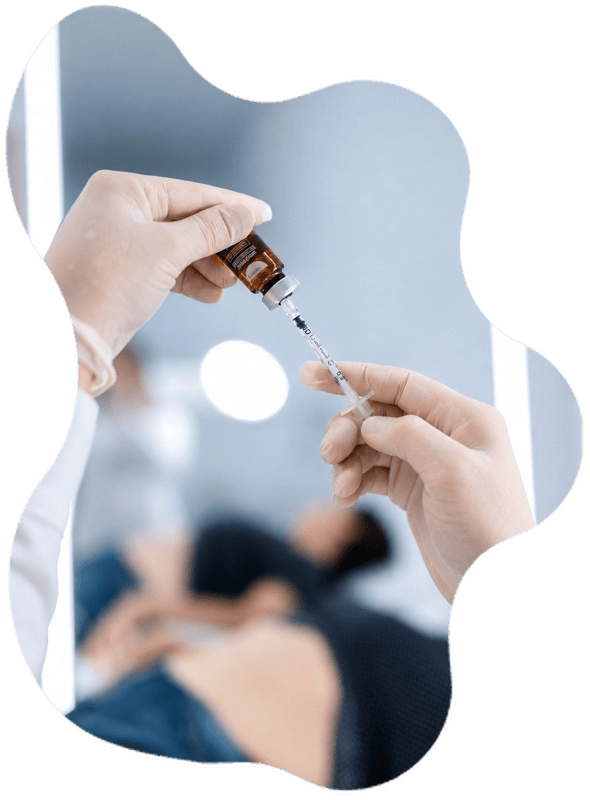 Healthcare professional preparing an injection in a clinical setting